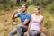 Young happy couple smiling while sitting on a stone