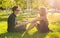 Young happy couple talking together outdoor - sitting on grass