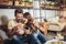 Young happy couple using digital tablet and eating pizza in a restaurant. Selective focus