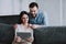 Young Happy Couple Using Tablet Device at Home.