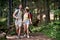 A young happy couple is walking the forest path on the mountain. Trip, nature, hiking