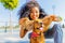 young happy curls hair woman playing with american cocker on the beach alley in sun light palms background