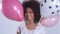 Young happy cute woman with balloons smiling, close up.