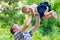 Young happy dad playfully tosses his little daughter