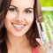 Young happy dark haired girl with glass of water