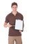 Young happy delivery man showing form on clipboard