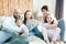 Young happy family of five on bedroom