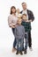 Young happy family with three children is standing. Love and tenderness. Full height. White background. Vertical