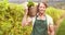 Young happy farmer holding a basket of vegetables