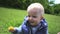 Young happy father gives yellow dandelion to his little son In park