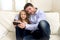 Young happy father showing sweet little girl using internet on mobile phone having fun together