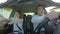 Young happy fun couple singing and dancing in the car -