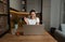 Young happy girl or woman talking on video call and waving with hand to her boyfriend who is on assignment as military soldier