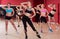 Young happy girls performing modern dance in fitness studio