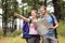 Young happy hikers pointing in the distance with a map