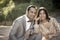 Young happy Indian couple sitting together outdoors