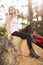 Young happy jogger sitting on rock and looking away