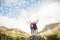 Young happy joggers standing on rock cheering