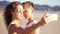 Young happy lesbian couple doing selfie on the beach