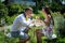 Young happy man sits with girlfriend and drinks tea at the table with sweets