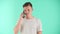 Young happy man is talking on the phone standing over blue studio background. Young entrepreneur organizes business