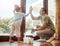 Young happy mixed race father and son giving each other a high five while cleaning at home. Little hispanic boy helping