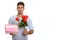 Young happy Persian man smiling while holding gift box and red r