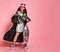 Young happy plus size girl model in stylish floral printed casual clothing, metallic coat, sneakers and modern accessories