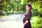 Young happy pregnant woman with long beautiful tress relaxing a
