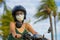 Young happy and pretty Asian Chinese woman riding scooter wearing motorcycle helmet and protective face mask in motorbike safe rid