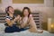 Young happy and pretty Asian Korean girlfriends sitting at home bedroom laughing and talking having fun using internet social