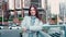 Young happy professional business woman standing on street, portrait.