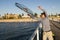 Young happy and proud attractive fisherman throwing fish and crabs basket net at sea dock sunset in man fishing as weekend hobby