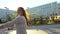 Young happy romantic woman cycling happily through a sunny street in summertime outdoors. Young teen girl riding bicycle