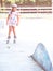 Young happy skater trying exciting outdoor activity