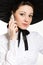 Young happy smile elegant woman with mobile phone wearing black & white Victorian style dress & hat