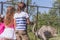 Young happy smiling kids feeding emu ostrich on bird farm