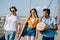 Young and happy street musicians carrying instruments