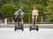 Young happy tourist couple riding segway enjoying city tour in Madrid park in Spain together