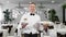 Young happy waiter while serving food in a restaurant