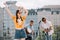 Young happy woman dancing to music played by buskers