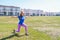 Young happy woman doing stretching workout outdoors, yoga pose