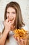 Young happy woman eating chips