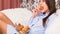 Young happy woman eating deep fried chicken, closeup. Woman eats chicken wings, calorie intake and health risks