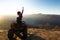 Young happy woman enjoying extreme ride on atv quad motorbike in autumn mountains at sunset