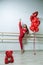 Young happy woman goes in for sports near her a gift for Valentines Day heart shaped balloons