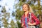 Young happy woman hiker hiking in forest