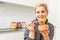 Young Happy Woman holding honey Enjoying While cooking healthy food In Kitchen. Detox Diet, Weight Loss Nutrition