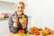 Young Happy Woman holding honey Enjoying While cooking healthy food In Kitchen. Detox Diet, Weight Loss Nutrition