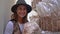 Young happy woman holding lion mane mushrooms and sniffing it